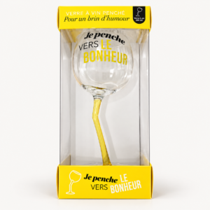 Verre à vin penché jaune Je penche vers le bonheur dans sa boîte sur fond pâle
